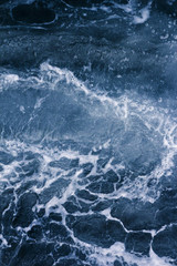 Fototapeta na wymiar Abstract blue background with white veins, ocean wave, bubble and foam at high tide, pattern