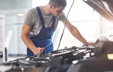 Auto mechanic working in garage. Repair service