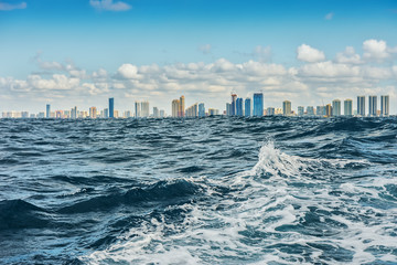 View from the waters of the stormy ocean on the coast of Mayamy. Skyscrapers at the water's edge. Selective focus.  USA, Florida,   © Ann Stryzhekin