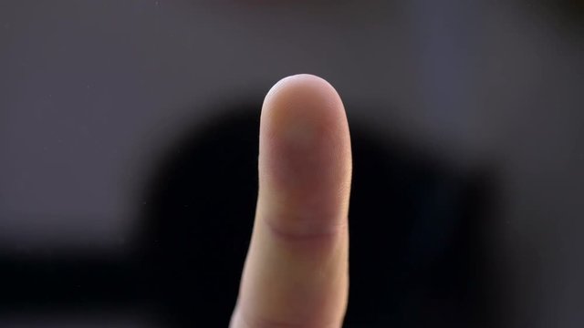 technology and human body parts concept - finger touching transparent screen or glass