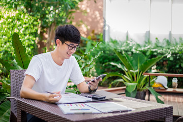 Stylish young businessman talking on the phone outdoors