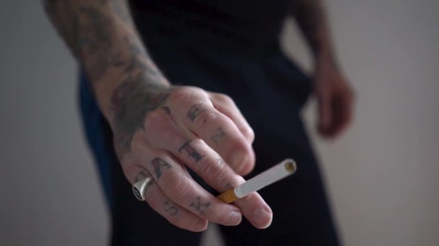 tattoed hand cigarettes