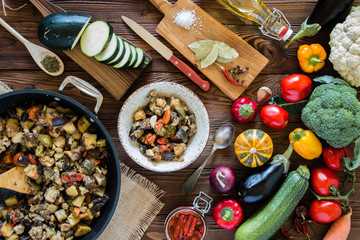 vegetable stew in the  pan and plate and fresh vegetables ingredients on wooden table,  top view - 205387053