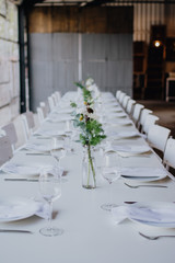 White Dining Table at wedding with flowers at beautiful venue