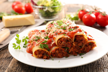 homemade cannelloni with beef and tomato sauce