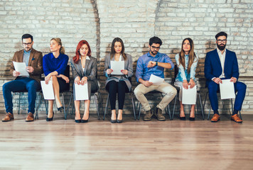 Photo of candidates waiting for a job interview - obrazy, fototapety, plakaty
