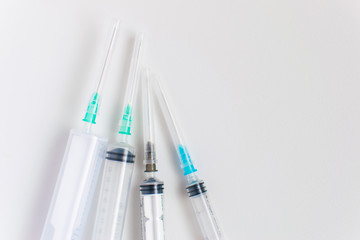 Different syringes on a white background.