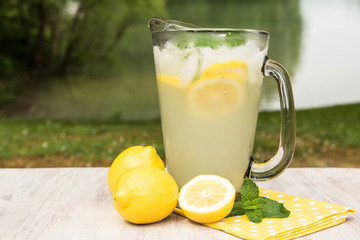 Pitcher of Lemonade Next To Lake
