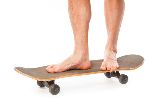 Man`s skateboarder legs close up isolated on white background