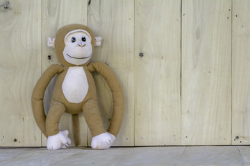 Monkey doll  on a wooden floor.
