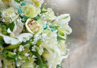 Wedding rings and bouquet. The background. Wedding decorations. Floristics.