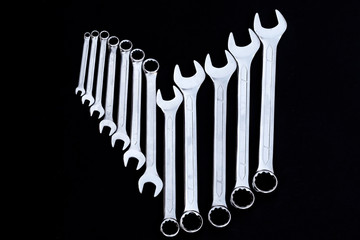 Set of chrome wrenches on black background. Car workshop concept.
