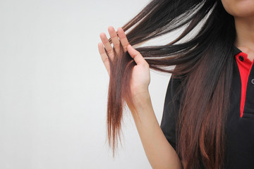 Woman holding at damaged splitting ends of hair, Haircare concept