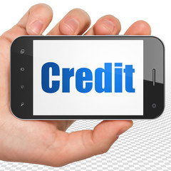 Finance concept: Hand Holding Smartphone with blue text Credit on display, 3D rendering
