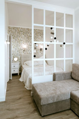 Cozy bedroom, nightstand and wardrobe. Life-changing minimalism