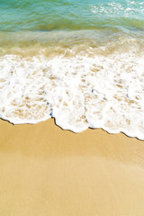 Background of blue sea wave on sandy beach.
