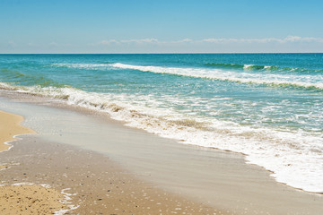 Fototapeta na wymiar Diagonal composition of sand beach shore with the blue sea