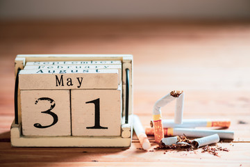 World No Tobacco Day, May 31. Close up Broken cigarette with Wooden Block calendar on wooden table background.
