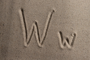 Letters of the English alphabet drawn on sand 