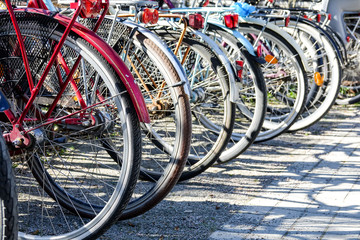 Old bikes on a bicycle parking lot.