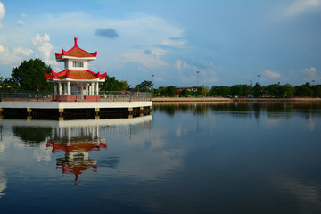 Naklejka premium a chinese style pavilion in the water park city with blue sky and clouds