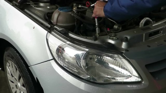 car fuel up with gas. close up refueling gun in the neck of the tank