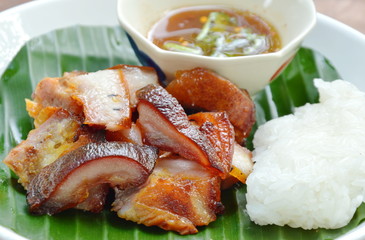 barbecue pork belly with sticky rice and dipping spicy sauce on plate