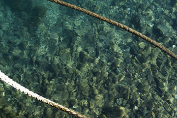 Rope floating over the clear surface of a clear and blue water