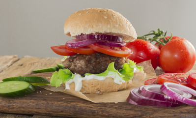 Delicious burgers with beef, tomato, cheese and lettuce