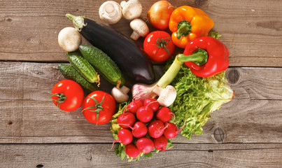 Pile of organic vegetables on a wooden table