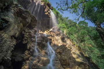 Tumpak Sewu Waterfall water soft, bright sunlight.