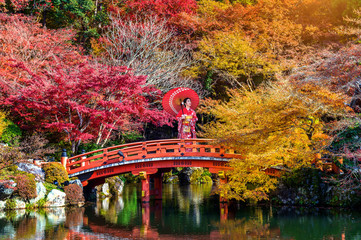 Fototapeta na wymiar Asian woman wearing japanese traditional kimono in autumn park. Japan