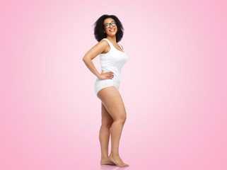 Fototapeta na wymiar body positive and people concept - happy african american woman in white underwear over pink background