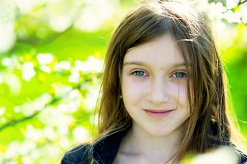Kid girl in blooming apple garden