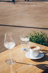 close-up of cup of cappuccino on a table in city cafe