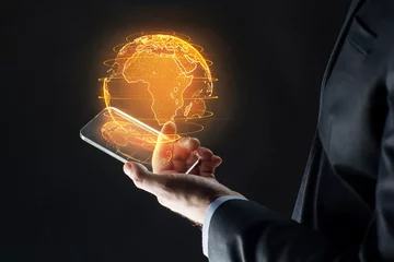 Fotobehang business, globalization and future technology concept - close up of businessman hand with transparent smartphone and earth hologram over black © Syda Productions