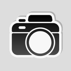 Photo camera, simple icon. Sticker style with white border and s