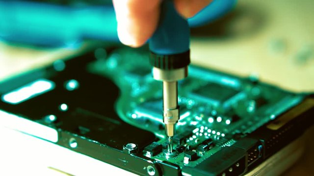Dismantling with the help of hand tools. Screwdriver with interchangeable attachments.