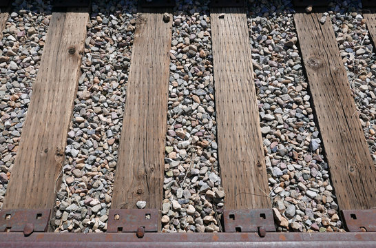 Railroad track with wooden ties on gravel