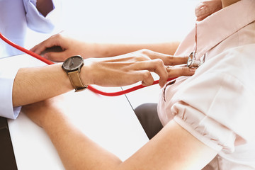 The concept of annual health check, the doctor is checking the rhythm of the heart.