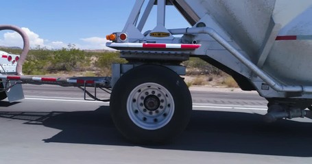 pov shot of tanker truck traffic on highway. Truck and camera by side - August 2017: Interstate 15, California, US