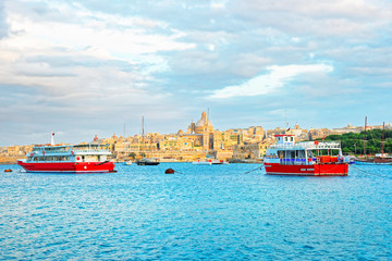 Fototapeta premium Valletta Skyline with St Paul Cathedral and ferry boats