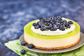Delicious key lime cheesecake decorated with fresh blueberries