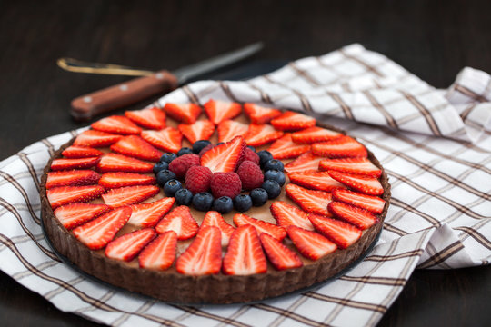 Delicious chocolate tart decorated with fresh berries