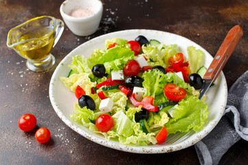 Fototapeta na wymiar Greek salad with fresh vegetables, feta cheese and black olives