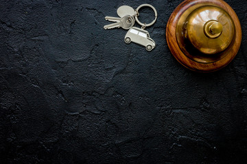 booking hotel room, ring and keys dark desk background top view 