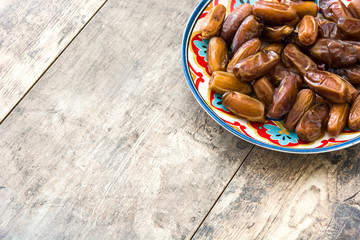 dates food in plate on wooden table