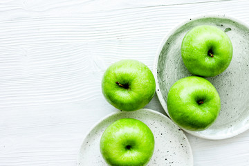 Healthy green food with apples on plates white background top vi
