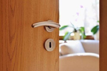Half opened door into the cozy home interior