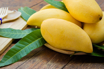 sweet yellow mango fruit on summer on wood table